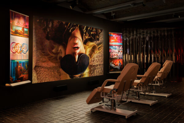 Andrea Khôra, RAPTURE, 2024. Video, sound, 24′10″, medical chairs, roller banners. Courtesy the artist