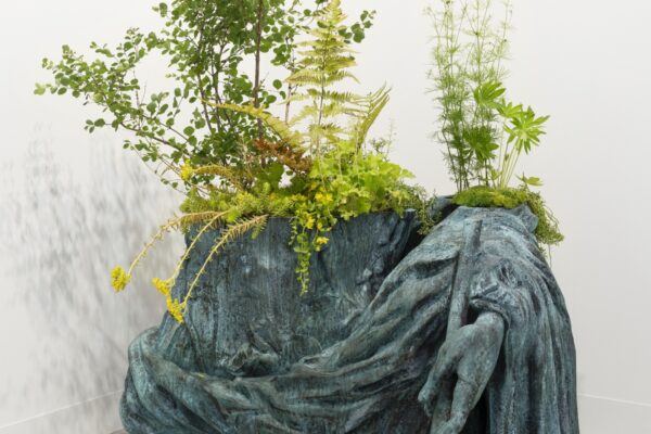 Iván Argote, Wild Flowers, Augustus: A Hip, 2024; bronze, wild flowers and local weeds and soil; bronze: H 60 cm x L100 cm x D 85 cm, vegetation: variable dimensions © Courtesy of the artist and Perrotin